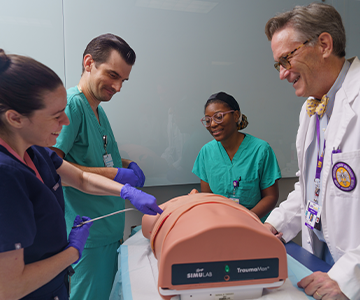 Medical students practice their craft on a medical dummy. Links to Tangible Personal Property Medical students practice their craft on a medical dummy. Links to Tangible Personal Property