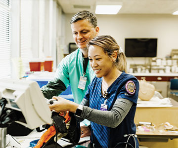 Medial professionals preparing a medical device for a patient. Links to Gifts from Retirement Plans Medial professionals preparing a medical device for a patient. Links to Gifts from Retirement Plans